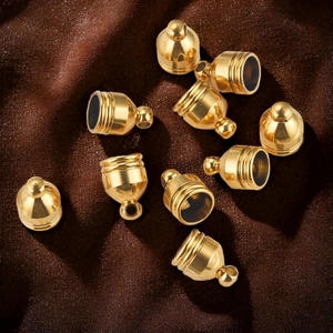 Close-up of gold plated stainless steel bell shaped cord ends for DIY jewelry making