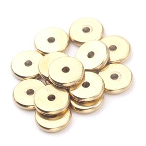 Close-up of golden stainless steel flat beads with center hole for DIY jewelry making