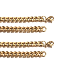 Polished gold stainless steel Cuban link necklaces with secure lobster clasps on white back