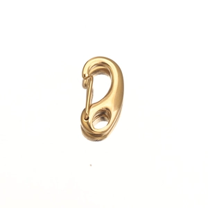 Close-up of golden polished stainless steel lobster clasp accessory with mirror finish