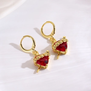 Detailaufnahme goldener Rosen-Ohrringe mit roten herzförmigen Zirkon-Anhängern