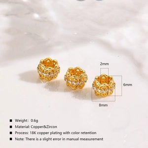 Detail view of 8x6mm hollow gold spacer beads with inlaid white zircon and 2mm hole