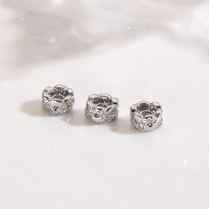 Macro shot of silver plated flower spacer beads with micro-pave cubic zirconia stones