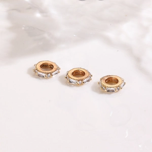 Macro detail of 18K gold plated spacer beads with inlaid clear cubic zirconia crystals