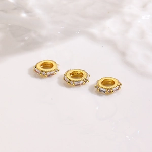 Detailed view of 18K gold-plated spacer beads with zircon for DIY jewelry making