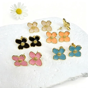 Detail view of five-color floral earrings set in 18k gold plated copper with enamel finish