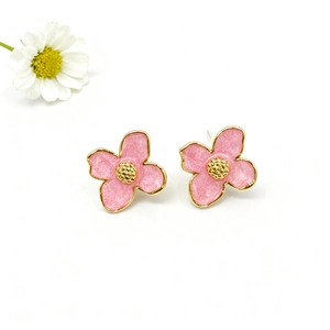 Close-up of pink enamel four-leaf flower studs with 18k gold plating and beaded center