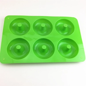 Detailed top view of 6-cavity green silicone donut mold for baking and chocolate making