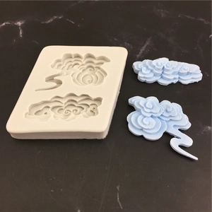 White silicone mold for baking with two traditional lucky cloud patterns for cake decor
