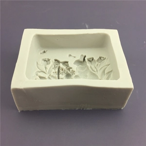 Macro shot of rectangular silicone mold with intricate floral embossed texture for crafts