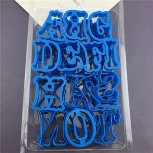 Set of large blue plastic alphabet cookie cutters and clay molds in tray packaging