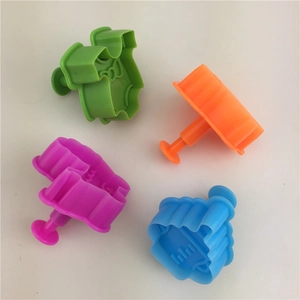 Set of 4 colorful plastic spring-loaded cookie cutters with baby clothing and bib shapes