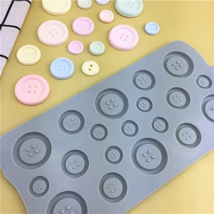 Detail view of silicone button mold showing various sizes and cavities for cake decoration
