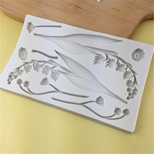 White silicone mold featuring lily of the valley flower designs for fondant and clay crafts