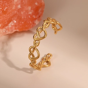 Polished 18K gold-plated stainless steel open bangle with hollow heart design motifs