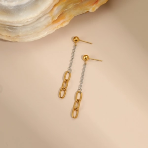 Detail of long gold and silver mixed chain earrings with chunky oval link drop pendants