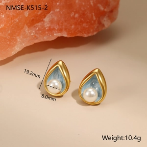 Detailed view of teardrop pearl earrings with blue enamel and 18k gold plating details