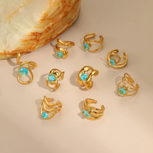 Set of irregular hollow stainless steel 18K gold plated rings with blue zircon stones