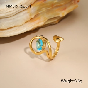 Detail view of 18K gold plated ring with blue oval zircon and irregular hollow design