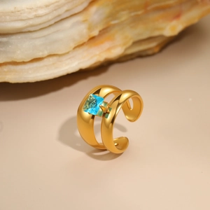Detail of 18K gold-plated stainless steel ring with square blue zircon and open design