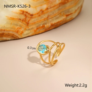 Detailed macro view of gold-plated triple coil ring with 0.7cm blue zircon stone