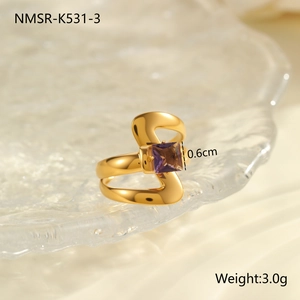 Detail view of wavy gold-plated stainless steel ring with 0.6cm purple zircon inlay