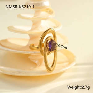 Detailed macro view of an irregular gold-plated ring featuring a purple zircon gemstone
