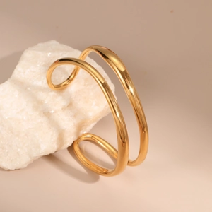 Minimalist double-layer 18K gold-plated stainless steel open bangle on white stone
