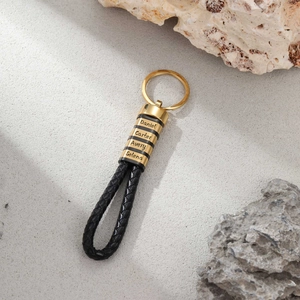 Custom braided leather and stainless steel keychain with engraved gold name rings