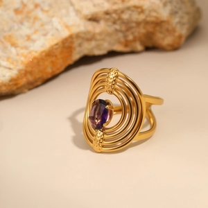 Detail of 18K gold plated ring featuring tiered design and purple oval zircon inlay