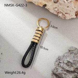 Detail view of woven leather keychain with golden metal finish and 10.5cm length dimensions
