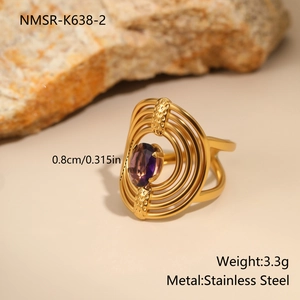 Close-up of gold irregular stainless steel ring with oval purple zircon inlay and specs