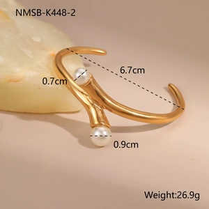 Detail view of 18K gold plated stainless steel cuff bracelet with two white pearls