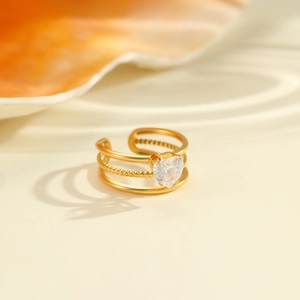 Detail view of gold triple-layer adjustable ring featuring a heart-shaped zircon stone