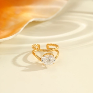 Detail of 18K gold-plated adjustable ring featuring oval zircon and twisted rope band