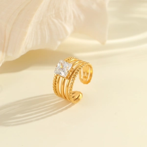 Detail of 18K gold-plated stainless steel ring with square zircon and multilayer hollow band