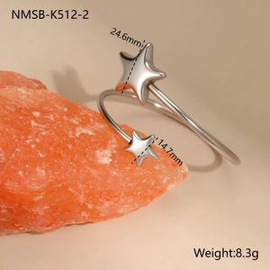 Detailed close-up of a polished stainless steel star-shaped open cuff bracelet with dimensions