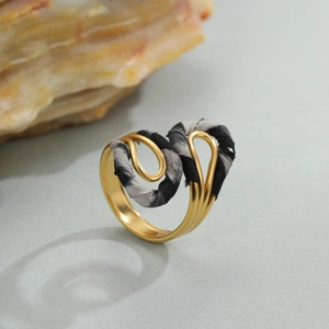 Gouden roestvrijstalen ring met luipaardprint stofaccenten en modern golfontwerp