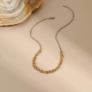 Detail of two-tone gold and silver chain necklace with lobster clasp and extension