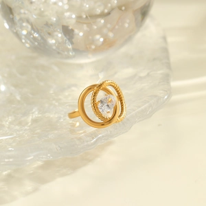 Detailed macro view of an 18K gold-plated stainless steel ring with zircon and woven band