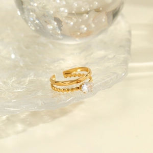 Detail of 18K gold-plated double-layer ring featuring an oval zircon on rippled texture