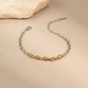 Close-up of dual-tone gold and silver stainless steel chain link necklace with lobster clasp