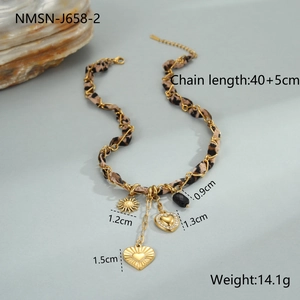 Detailed close-up of 18K gold plated heart and leopard print charms on stainless steel chain