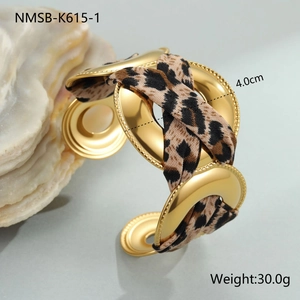 Detail view of 18K gold plated cuff bracelet with leopard print ribbon knot and 4cm width