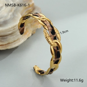 Macro detail of 1.9cm wide 18K gold plated stainless steel cuff with leopard print silk inlay