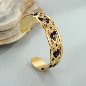 Detailed view of wide 18K gold plated cuff bracelet with leopard print ribbon inlay