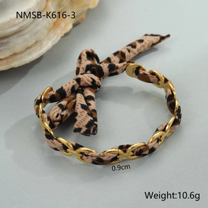 Detail view of leopard print ribbon entwined with 18K gold plated chain and bow knot