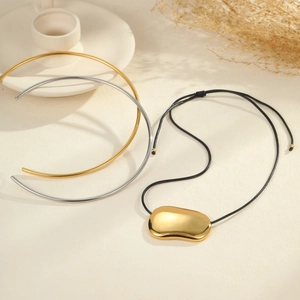 Minimalist titanium steel necklace set with irregular gold pebble pendant on black cord