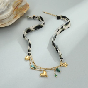 Detail van luipaardprint zijden lint ketting met gouden hart hanger en gekleurde kralen