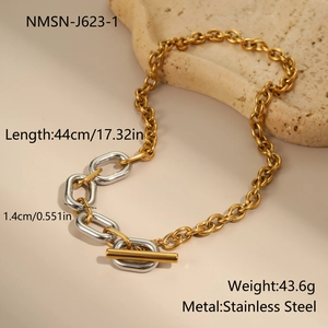 Macro shot of gold and silver tone mixed chunky chain necklace with OT toggle clasp